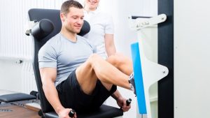 Physiotherapist exercising patient in sport therapy